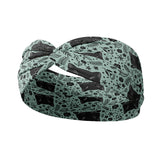 Adult women's sage headband with black cat art peaking over with small black flower and dot outlines