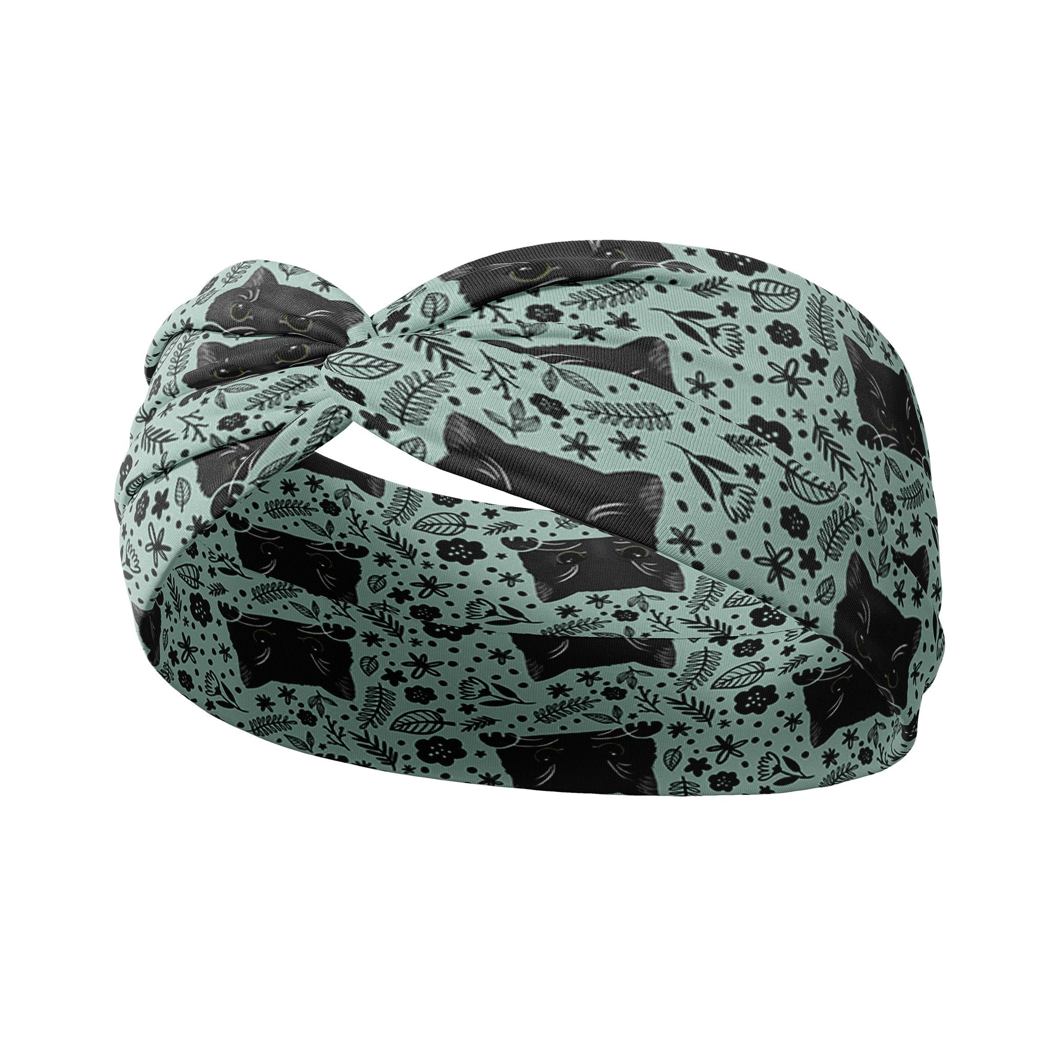 Adult women's sage headband with black cat art peaking over with small black flower and dot outlines