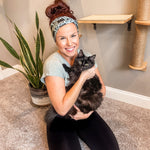 Adult women's sage headband with black cat art peaking over with small black flower and dot outlines