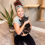 Adult women's sage headband with black cat art peaking over with small black flower and dot outlines