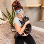 Adult women's sage headband with black cat art peaking over with small black flower and dot outlines