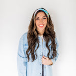 Adult women’s headband with allover layered watercolor paint brushstroke print in varying oranges, pinks, yellows, blues, greens and whites.