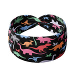 Adult women's black headband with orange, red, blue, grey and pink dinosaur silhouettes with similar colored plants