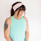 Adult women's white headband with orange, slate, tan, blush and plum pawprints, hearts and words they say "cat mom"